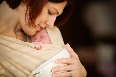 Mother holding newborn  girlの写真素材