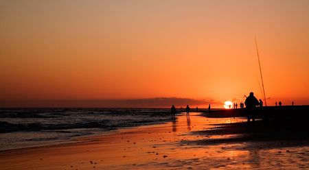 People on the beach at beautiful sunsetの写真素材