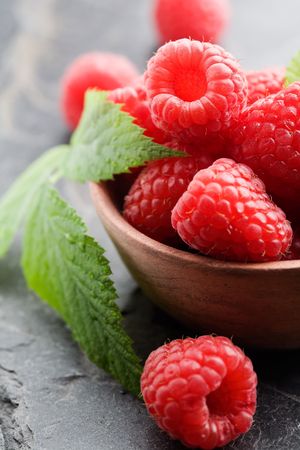 Fresh raspberries in brown bowl