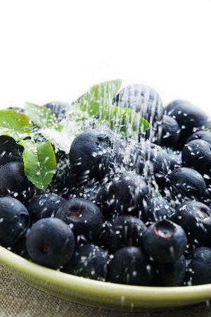 Pouring sugar on fresh blueberriesの写真素材
