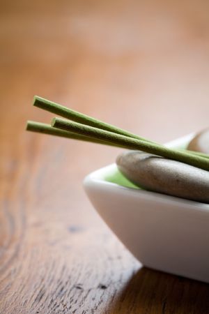Green incense sticks and  stones on bowlの写真素材
