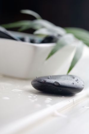 Black  stones in white bowlの写真素材