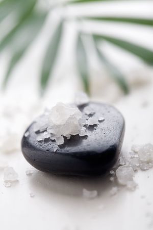White bath salt on black massage stoneの写真素材