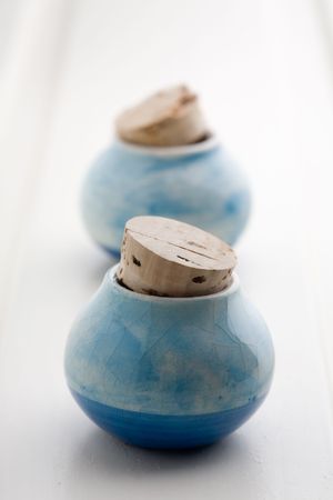 Blue little ceramic jars on white backgroundの写真素材