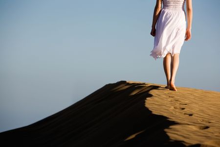 Woman walking on the beachの写真素材