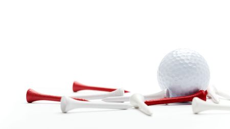 Golf ball and tees isolated on whiteの写真素材