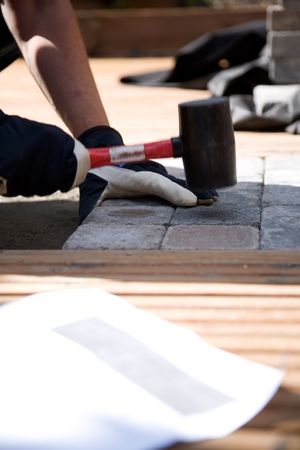 Building a patio with wooden terrace and stonesの写真素材