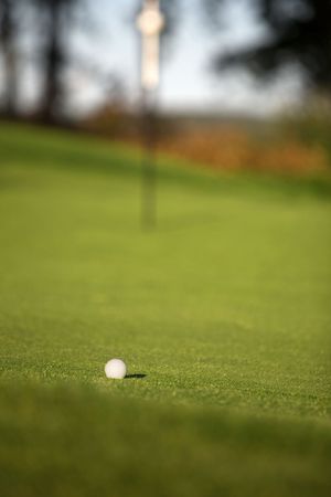 Golf green with one golf ball, shallow focusの写真素材