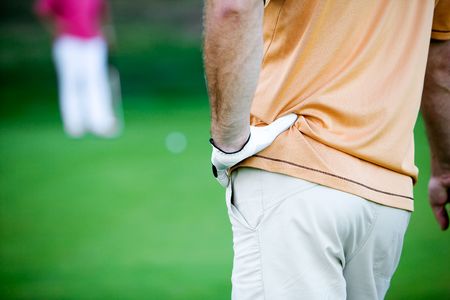 Golfer waiting for his turn, focus on handの写真素材