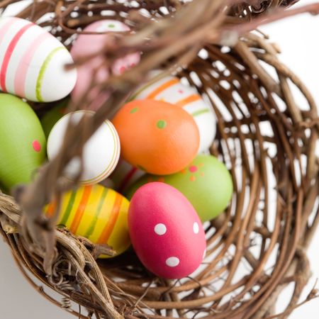Colorful painted easter eggs in brown basket