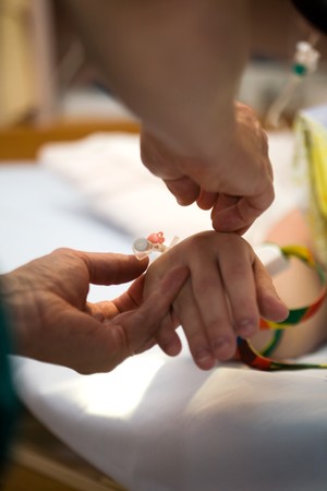 Drip on female patients hand, shallow focus