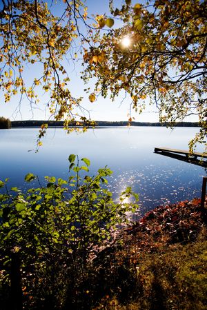 Autumn landscape with colorful trees by the lakeの写真素材