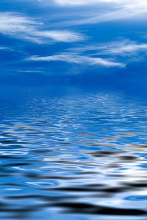 Blue sky with fluffy clouds and water reflectionの写真素材