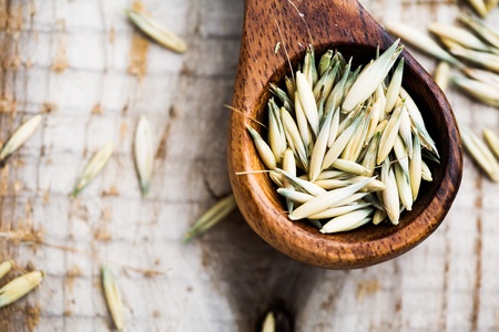 Close up of oat seeds on wooden tableの写真素材