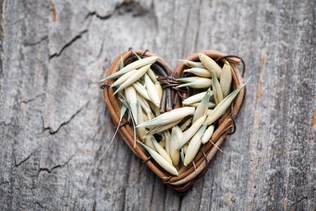 Close up of oat seeds on wooden tableの写真素材