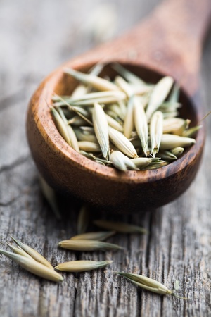 Close up of oat seeds on wooden tableの写真素材
