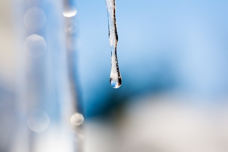 Icicles hanging from the edge of the roof, selective focusの写真素材