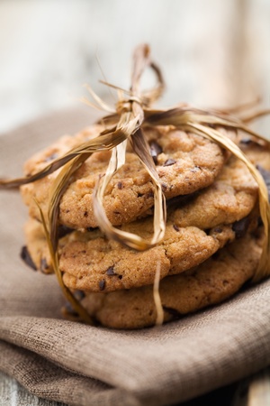 Pile of delicious chocolate chip cookies on table