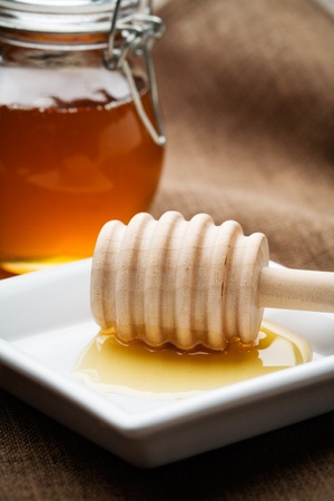 Liquid honey in small glass jar, selective focusの写真素材