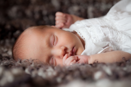 Newborn baby sleeping on the bedの写真素材