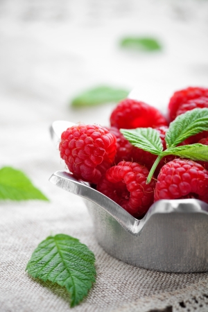 Bunch of fresh raspberries in white bowlの写真素材