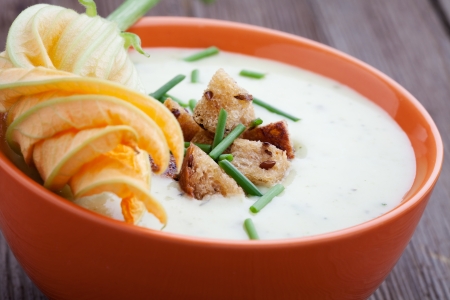 Bowl of zucchini soup with croutons and chivesの写真素材