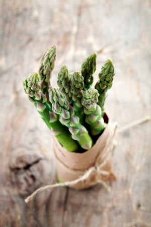 Bunch of fresh asparagus on wooden tableの写真素材