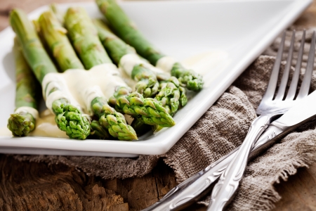 Bunch of fresh asparagus on wooden tableの写真素材