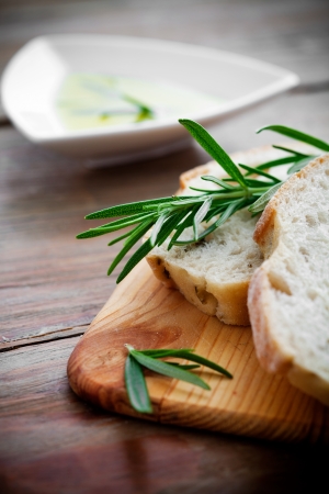 Fresh bread with olive oil and rosemaryの写真素材