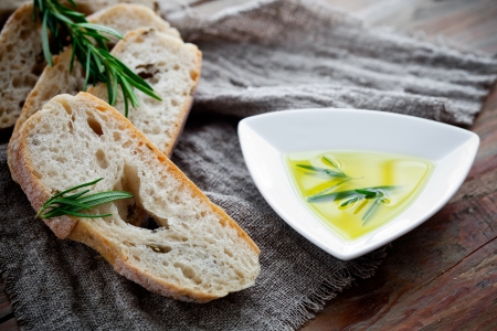 Fresh bread with olive oil and rosemaryの写真素材