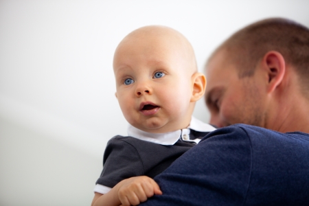 Father holding his son on his arms