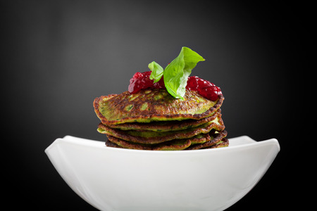 Healthy and delicious spinach pancakes with lingonberry jellyの写真素材