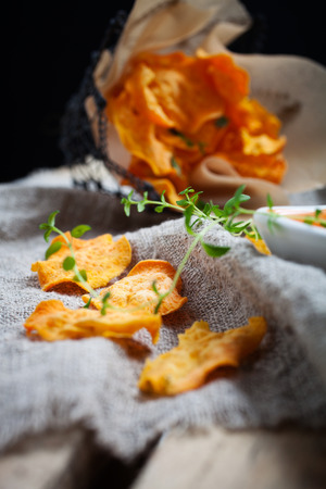 Homemade sweet potato chips with fresh thymeの写真素材