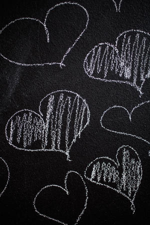 Hearts drawn in to black chalkboardの写真素材