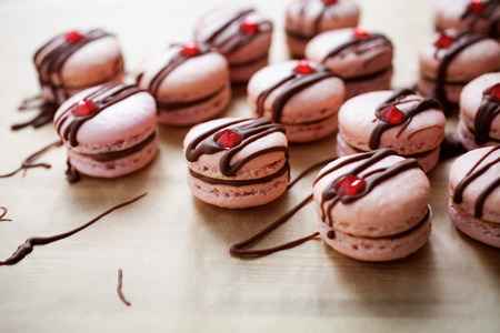 Pink macarons with chocolate and edible diamond