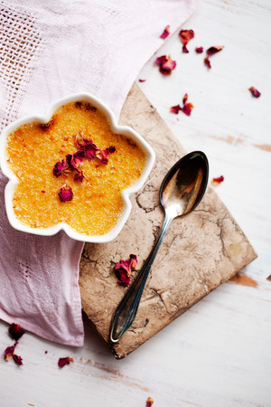 Homemade creme brulee with edble pink rosesの写真素材