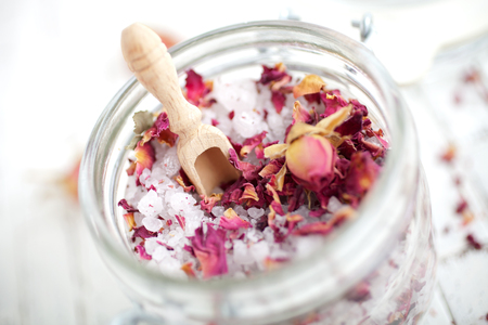 Homemade bath salt with pink rosesの写真素材