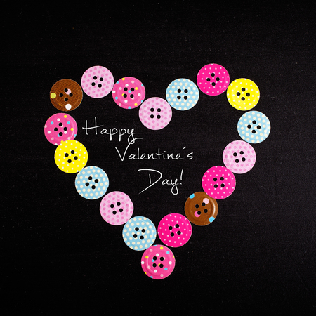 Heart shape made from paper buttonsの写真素材