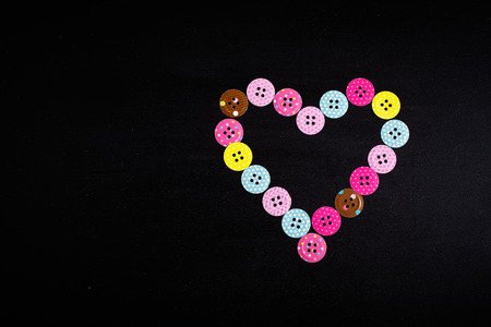 Heart shape made from paper buttonsの写真素材