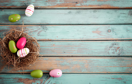 Colorful Easter eggs on wooden background