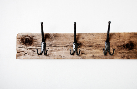 Empty wooden towel rack on white wallの写真素材