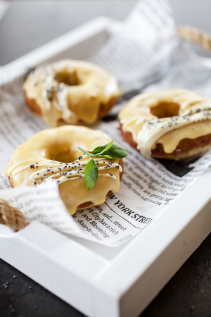 Lemon donuts with white chocolate and poppy seedsの写真素材
