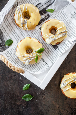 Lemon donuts with white chocolate and poppy seedsの写真素材