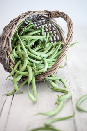 Group of green beans on white wooden table backgroundの写真素材