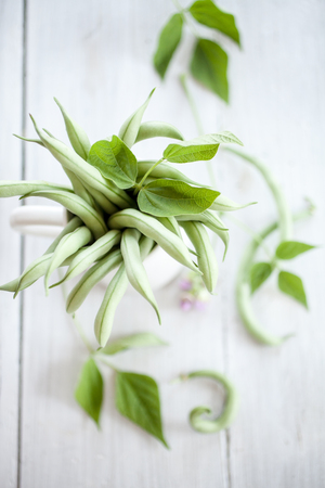 Group of green beans on white wooden table backgroundの写真素材