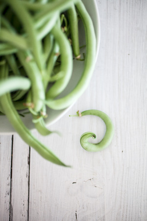 Group of green beans on white wooden table backgroundの写真素材