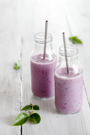 Healthy smoothie made with banana and blueberriesの写真素材