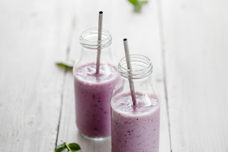 Healthy smoothie made with banana and blueberriesの写真素材