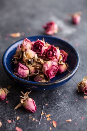 Dried pink rose buds on darkの写真素材