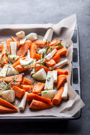 Fresh carrot and parsnip ready to be roastedの写真素材